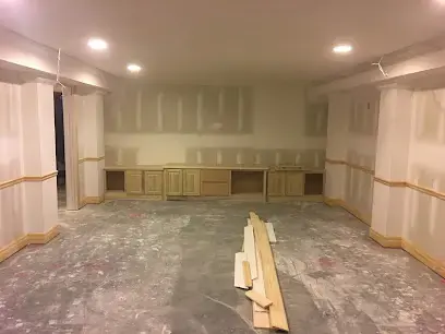 Basement rec room with the lower drywall cut away for drying in Blue Springs