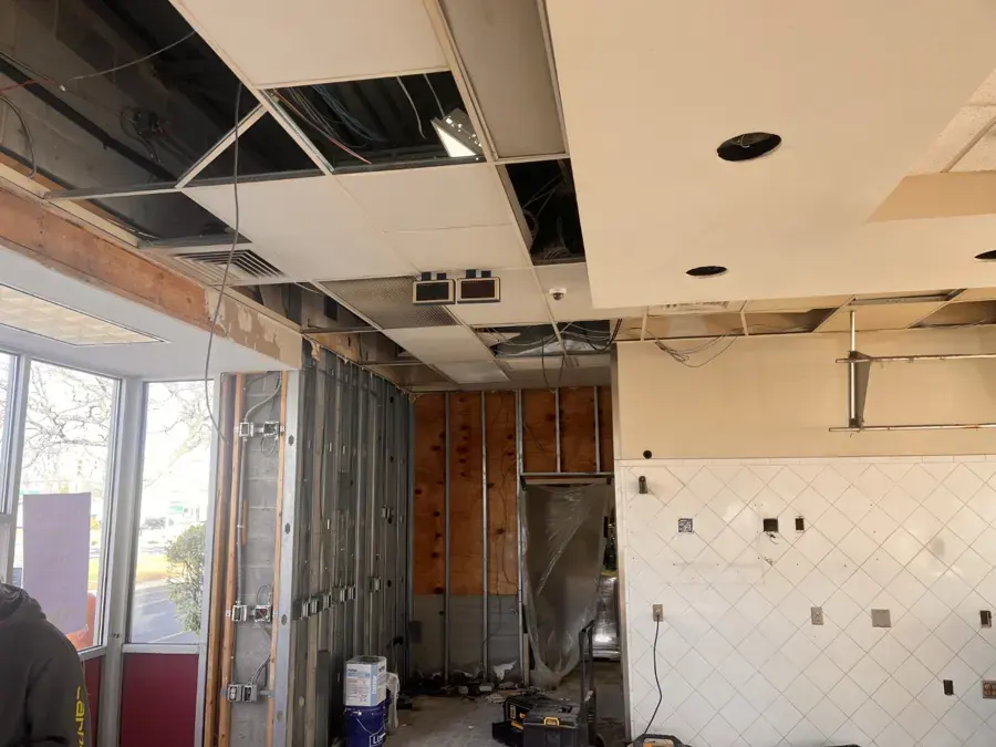 Kitchen with the ceiling and walls opened to the framing during a Blue Springs water loss
