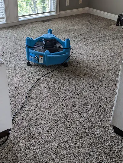 Dehumidifier and air mover equipment drying a stripped, wet room at a Raytown, Missouri property