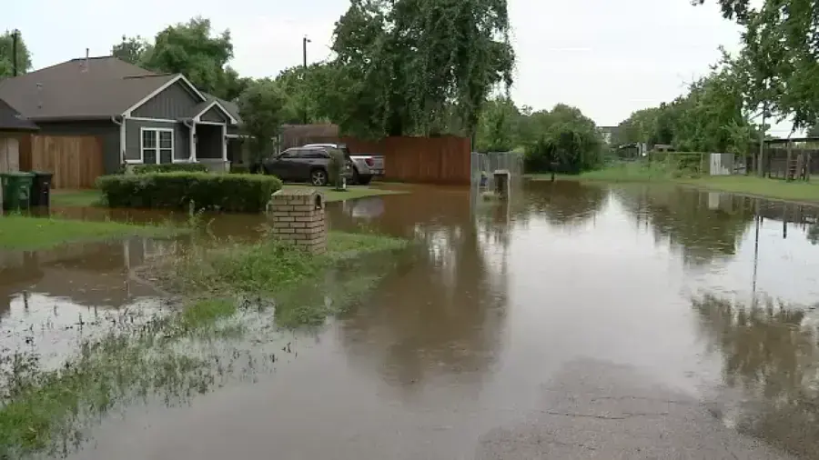 Storm water covering a residential street and front yards after heavy rain near Blue Springs, MO